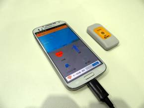 hitoeと連携中のアプリを表示中のスマートフォンと専用トランスミッター