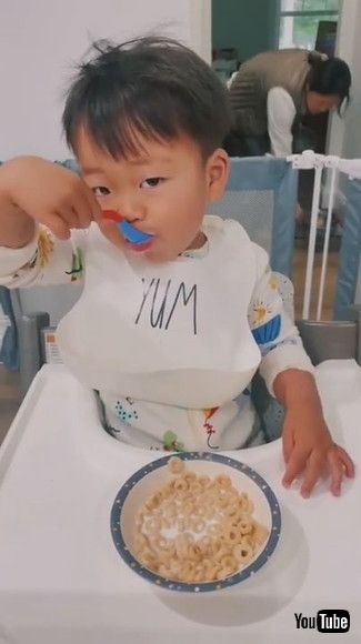 uToddler Spills Milk on the Floor While Trying to Pour it Into Bowl of Cereal - 1202181v
