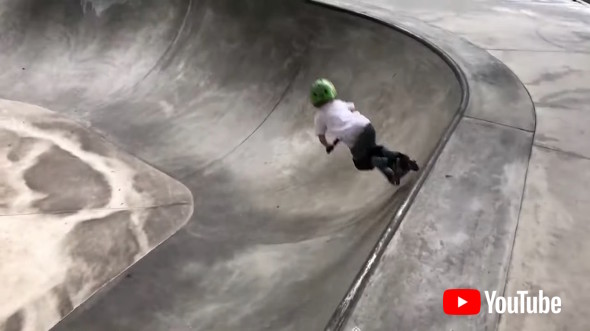 Little Kid Shows Tricks On Scooter While Practicing For Competition In Skatepark
