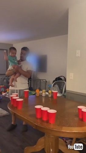 uToddler Participates in Beer Pong Game and Cheers Over Hitting Mark - 1261265v