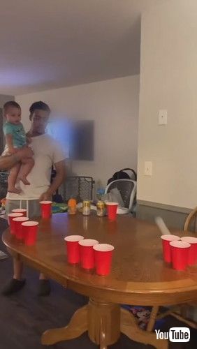 uToddler Participates in Beer Pong Game and Cheers Over Hitting Mark - 1261265v