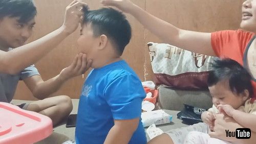 uBoy Watches in Amazement While Sibling Performs Magic Trick - 1205861v