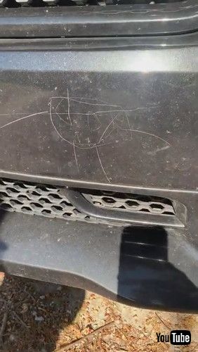 uLittle Kid Draws On Mother's Car With Screwdriver While Father Works Nearby - 1269650v