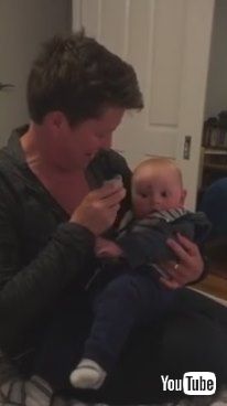 uBaby Laughs at Mom Putting Pacifier in Mouth - 985799v