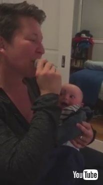 uBaby Laughs at Mom Putting Pacifier in Mouth - 985799v