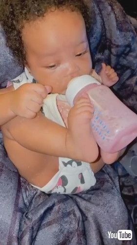 「Toddler Drinks Milk From Bottle While Holding it With Feet - 1278029」