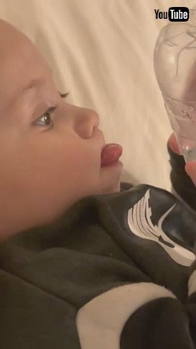 uBaby Tries Drinking Water From Bottom Of Bottle - 1279880v