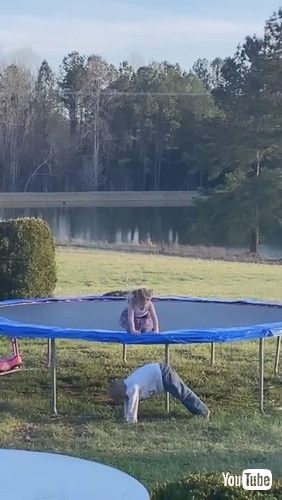 uKid Bends Down to Let Sister Climb Down from Trampoline - 1304263v