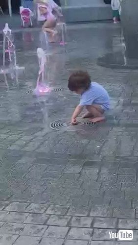 uToddler Gets Scared of Water Gushing Out of Fountain - 1371235v