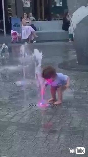 uToddler Gets Scared of Water Gushing Out of Fountain - 1371235v