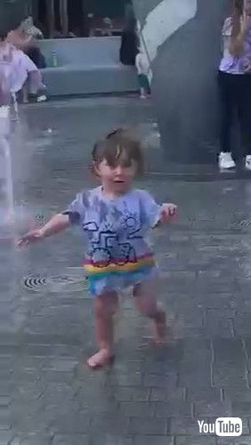 uToddler Gets Scared of Water Gushing Out of Fountain - 1371235v