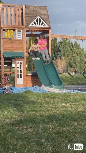 uGrandma Loses Balance and Falls Along With Grandson After Going Down Slide - 1417780v