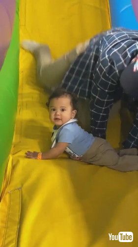 uFather Saves Son From Falling Off Inflatable Slide - 1423773v