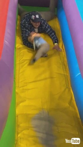 uFather Saves Son From Falling Off Inflatable Slide - 1423773v