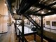 中小ビルを再生する「Reビル事業」で地方初、新聞社の旧輪転機室を天井高12.6mのオフィスにリノベ